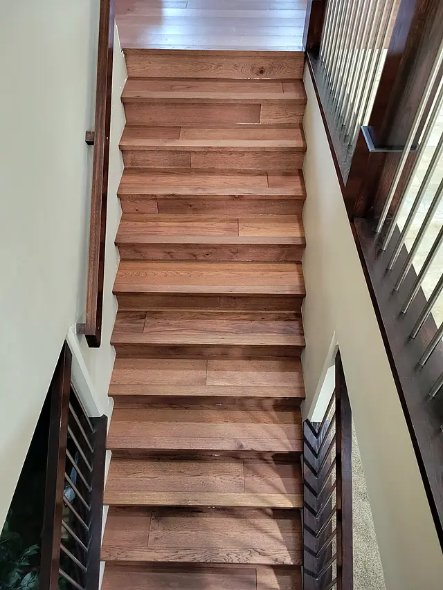 Warm-toned wood staircase seen from above